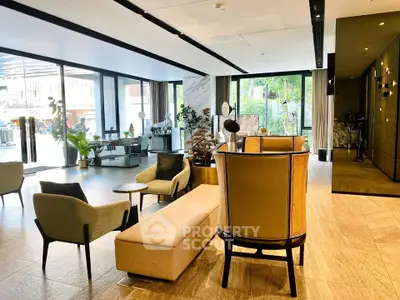 Luxurious modern living room with elegant furniture and large windows offering natural light.