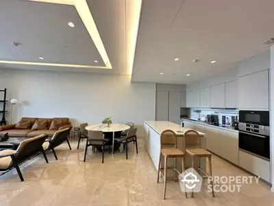 Luxurious open-plan kitchen and living room with modern furnishings and elegant lighting.