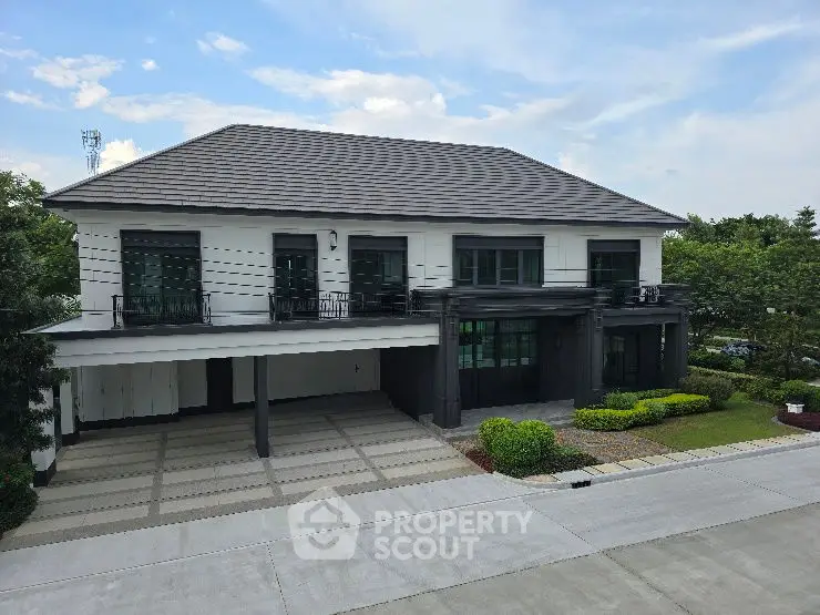 Elegant two-story modern house with spacious driveway and lush greenery