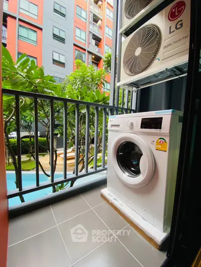 Modern balcony with washing machine and pool view in urban apartment