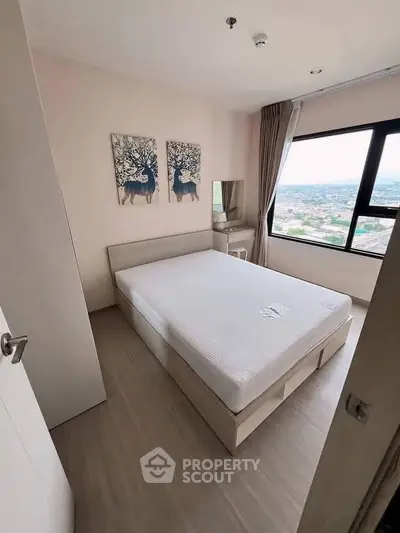 Modern bedroom with large window offering stunning city views and minimalist decor.