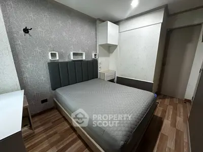 Modern bedroom with stylish decor and cozy ambiance, featuring a comfortable bed and elegant wallpaper.