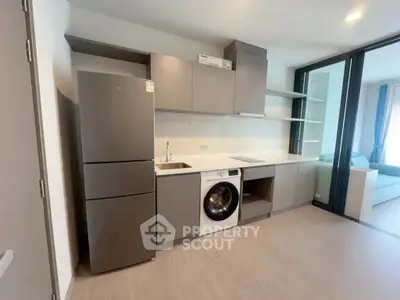 Modern kitchen with sleek cabinetry, integrated appliances, and open layout in a stylish apartment.