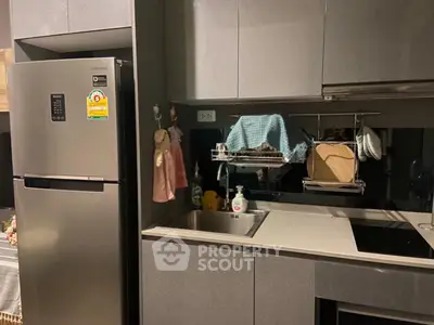 Modern kitchen with sleek cabinetry and stainless steel appliances, featuring a compact and efficient design.
