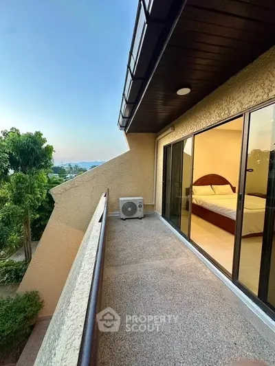 Spacious balcony with scenic view and bedroom access in modern home