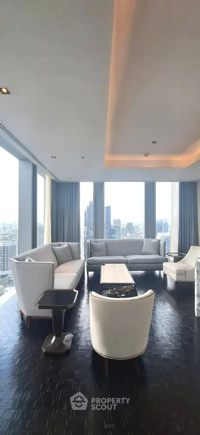 Luxurious high-rise living room with panoramic city views and modern furnishings.