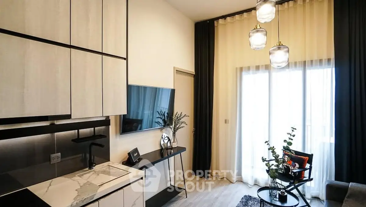 Modern living room with high ceilings, elegant lighting, and stylish decor in a contemporary apartment.