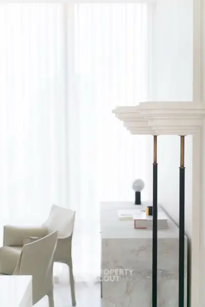 Elegant modern interior with stylish chairs and soft lighting, perfect for a sophisticated living space.