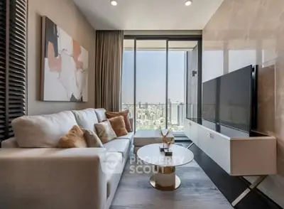 Modern living room with city view, stylish decor, and large TV