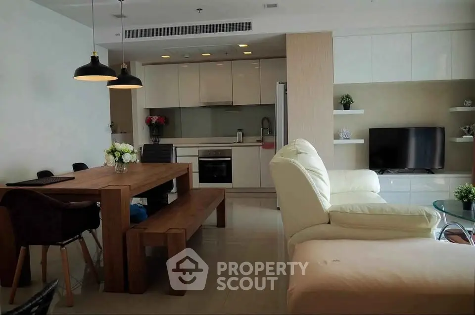 Modern open-plan living room with dining area and sleek kitchen design