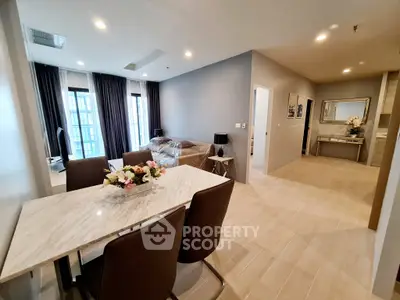 Modern open-plan living and dining area with elegant decor and natural light.