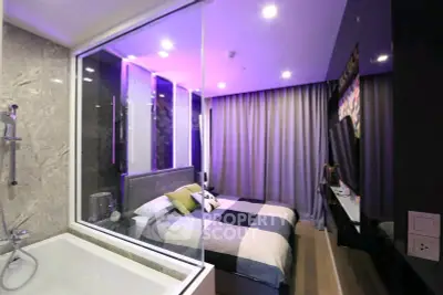 Modern bedroom with glass wall and bathtub, featuring stylish lighting and elegant decor.
