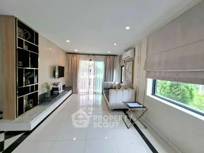 Spacious modern living room with large windows and elegant decor