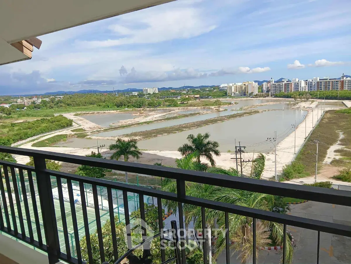 Stunning balcony view overlooking lush greenery and serene water bodies, perfect for relaxation and tranquility.