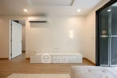 Modern minimalist living room with air conditioning and wooden flooring