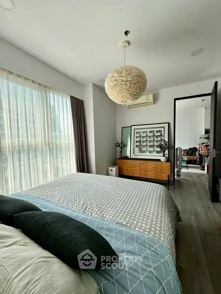 Modern bedroom with large window and stylish decor