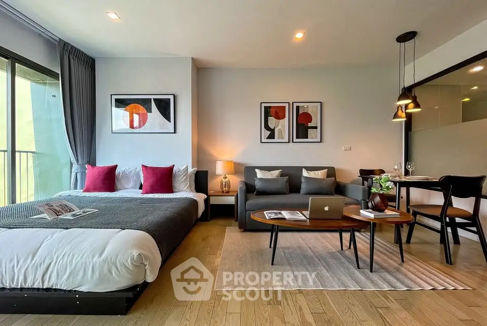 Modern studio apartment with stylish decor and open layout, featuring a cozy bed and chic living area.