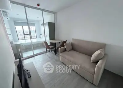 Modern living room with sofa and dining area in a bright apartment