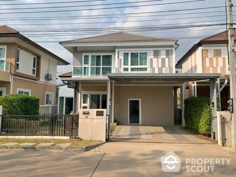 Modern two-story house with driveway and contemporary design in a suburban neighborhood.