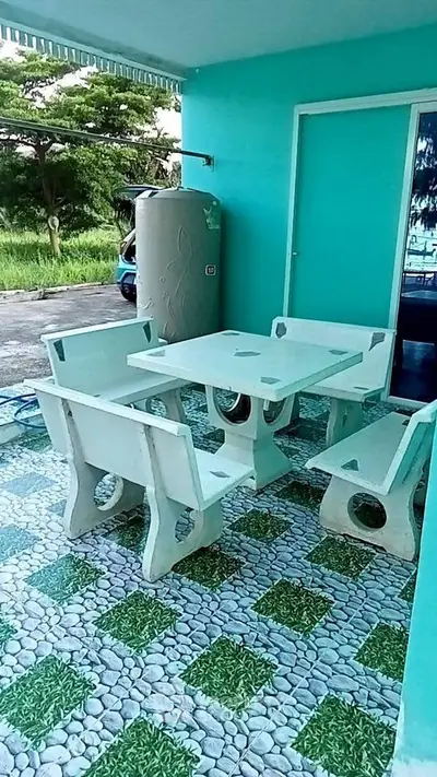 Charming outdoor patio with unique seating and vibrant turquoise walls