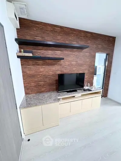 Modern living room with stylish wood accent wall and sleek TV unit
