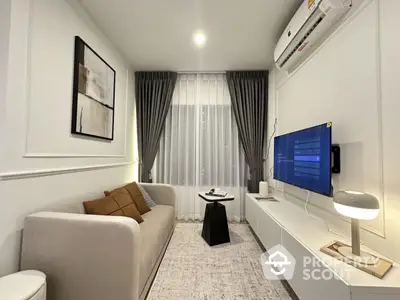 Modern living room with elegant decor and wall-mounted TV, featuring cozy sofa and stylish lighting.