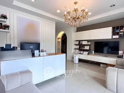Elegant living room with chandelier and modern decor, perfect for luxury home buyers.