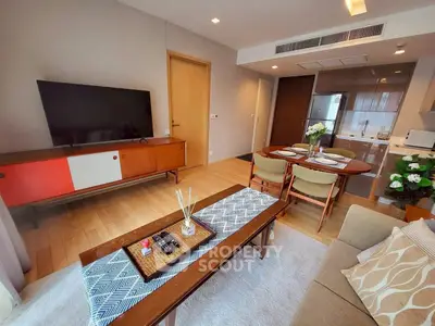 Stylish living room with modern furniture and open kitchen layout, perfect for cozy gatherings.