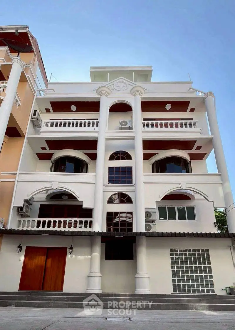 Stunning multi-story building with elegant architectural design and spacious balconies.