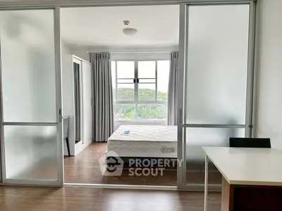 Spacious bedroom with large windows and sliding glass doors