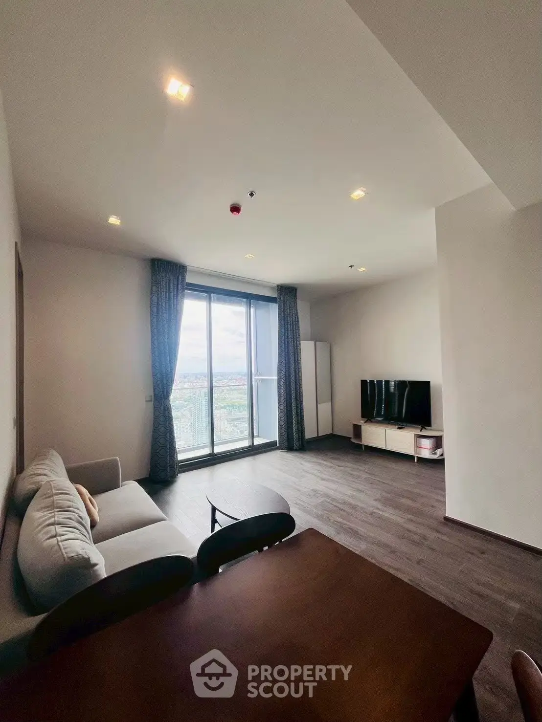 Spacious modern living room with large windows and stunning city view