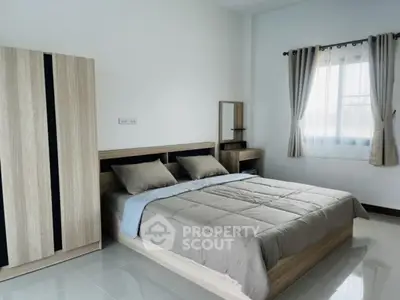 Spacious modern bedroom with stylish wooden furniture and natural light