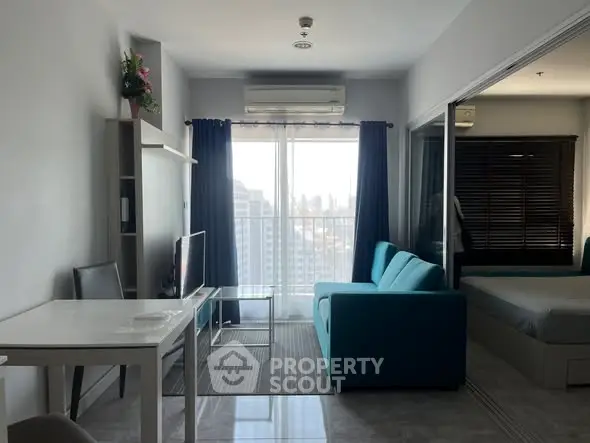 Modern studio apartment with bright living area and city view.