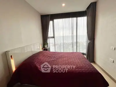 Modern bedroom with large window offering stunning city view and elegant decor