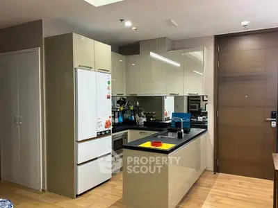 Modern kitchen with sleek cabinetry and built-in appliances in a stylish apartment.