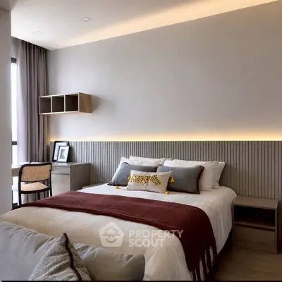 Modern bedroom with stylish decor and ambient lighting, featuring a cozy bed and elegant furnishings.