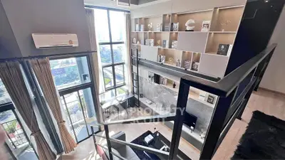 Stunning modern duplex with high ceilings and large windows offering panoramic city views.