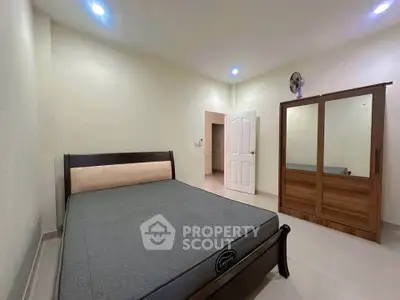 Spacious bedroom with modern bed and wardrobe, ideal for comfortable living.