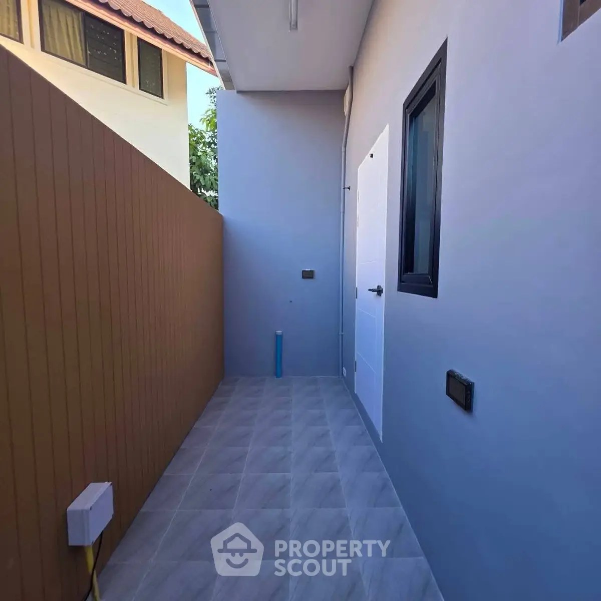 Modern outdoor corridor with sleek design and neutral colors, perfect for contemporary living spaces.