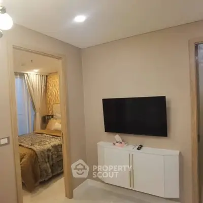 Modern bedroom with wall-mounted TV and cozy decor