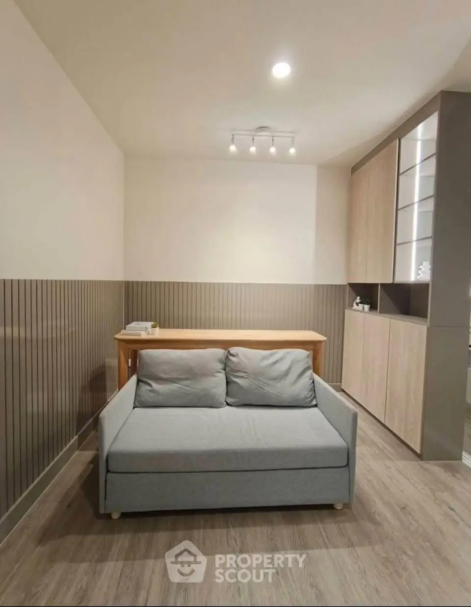 Modern living room with stylish sofa and wooden accents