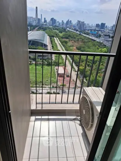 Stunning city view from a high-rise balcony with lush greenery and skyline in the background.