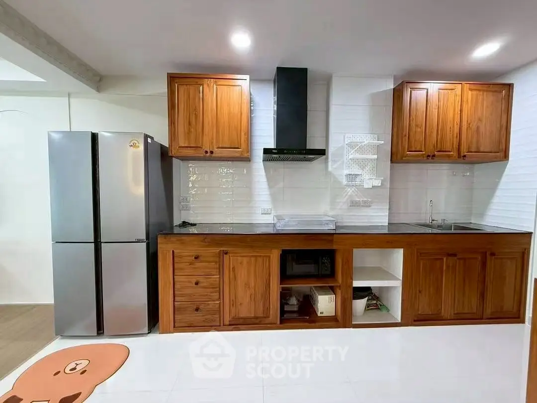 Spacious kitchen with wooden cabinets and modern appliances