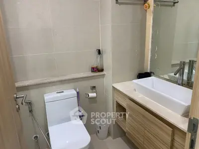 Modern bathroom with sleek fixtures and elegant vanity in a contemporary home.