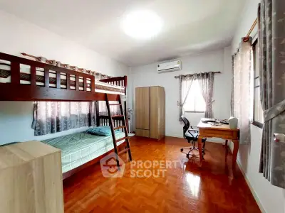 Spacious bedroom with bunk bed and study area, perfect for students or shared living.