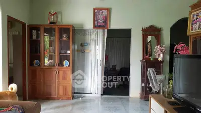 Cozy living room with wooden cabinet and decorative elements, perfect for family gatherings.