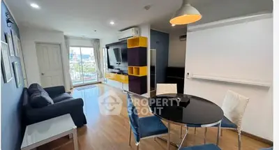 Modern living room with stylish furniture and large window offering city view