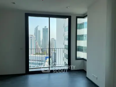 Modern apartment with floor-to-ceiling windows offering stunning cityscape views.