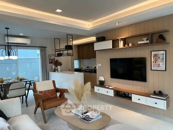 Modern open-plan living room with stylish decor and integrated kitchen area.