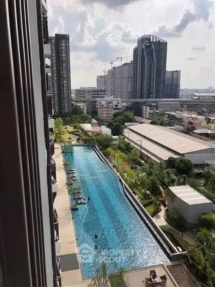 Stunning urban view with luxurious pool in modern residential complex.